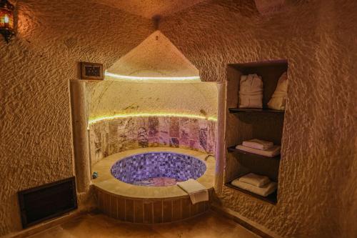 a small bathroom with a tub in a room at Utopia Cave Cappadocia in Urgup