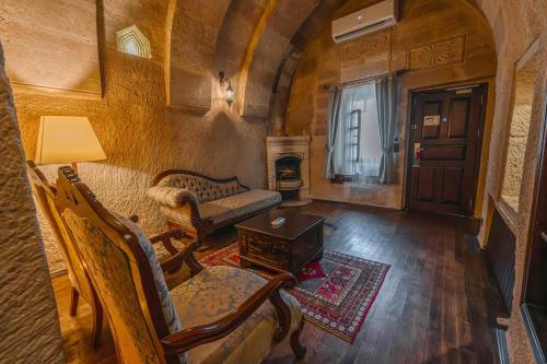 a living room with a couch and a table at Utopia Cave Cappadocia in Urgup