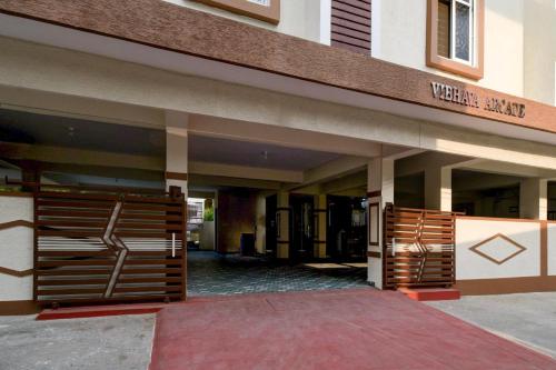 a entrance to a building with a wooden gate at Super Townhouse Oak Bachupally Medical College Formerly SV Hotels in Lingampalli