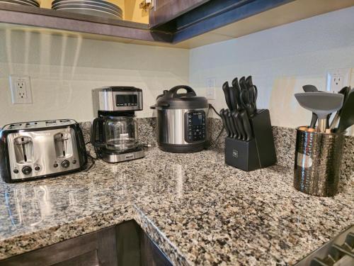 a kitchen counter with appliances on a granite counter top at 6BR Villa with POOL, BBQ, Temecula WINERIES in Winchester