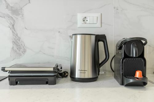 a coffee pot and a toaster on a counter at Magea Suites in Áyios Andónios