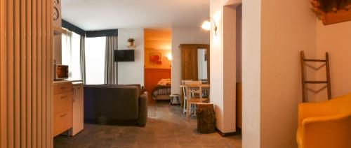 a room with a kitchen and a living room at Shackleton Chalet in Sestriere
