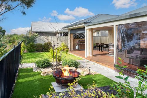 a garden with a fire pit in the middle of a yard at 13th Tee by the Sea- On the Golf Course in Dunsborough