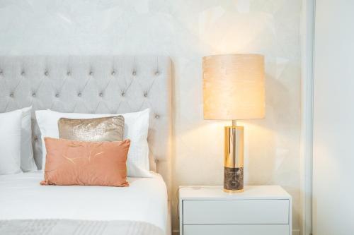 a bedroom with a bed with a lamp on a night stand at Nora Charming Apartment - Pool -10m Walk City Center in Funchal