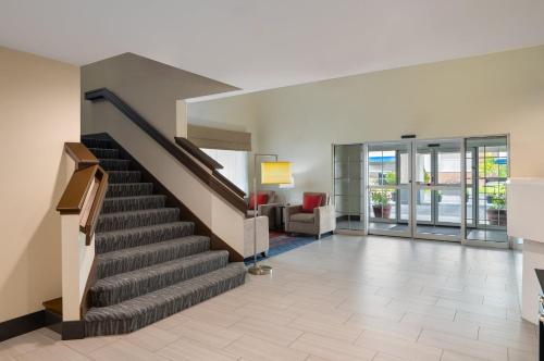 a lobby with a staircase in a building at Garner Hotel Londonderry - Manchester by IHG in Londonderry