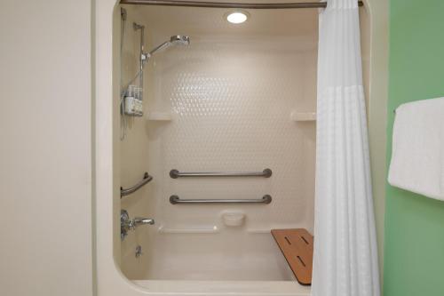 a shower in a bathroom with a shower curtain at Garner Hotel Londonderry - Manchester by IHG in Londonderry