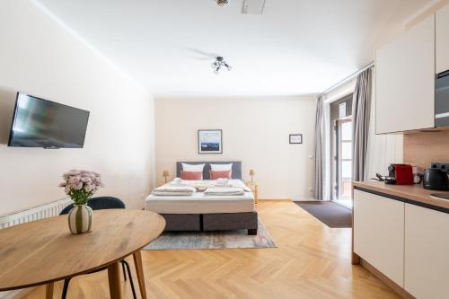 a living room with a bed and a table at Vienna Stay Apartments Schönbrunn in Vienna