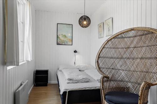 a small room with a bed and a chair at 406-Vestervig-Bekkasinvej-6 in Vestervig