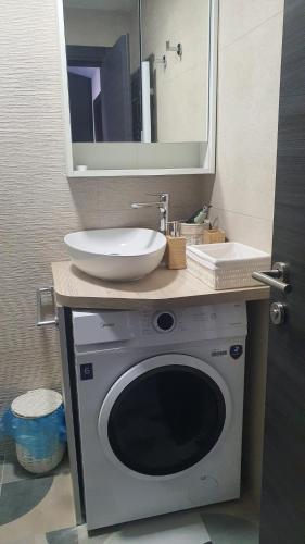 a bathroom with a sink and a washing machine at Innova TravelVir - Salt and Sun in Vir