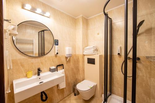 a bathroom with a sink and a shower at Hotel Stefani in Sibiu