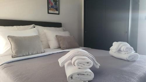 a bed with towels and pillows on it at Innova TravelVir - Salt and Sun in Vir