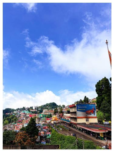 a view of a city with buildings and a flag at Hotel Zambala Retreat & Spa Darjeeling in Darjeeling