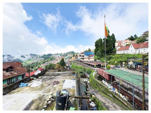a train yard with a flag on top of it at Hotel Zambala Retreat & Spa Darjeeling in Darjeeling