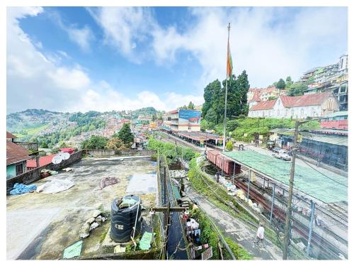 a view of a train yard with a train station at Hotel Zambala Retreat & Spa Darjeeling in Darjeeling