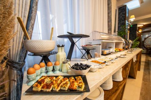 a buffet line with food on a table at Hotel Stefani in Sibiu