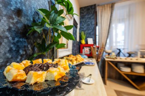a plate of food on a table with a cake at Hotel Stefani in Sibiu