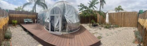 a dome house on a wooden deck in a backyard at J&L Glamping in La Presa
