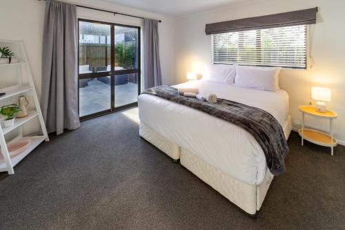 a bedroom with a large bed and a window at Urban Nest on Perth 3BR 1 and a half Bath Free Parking in Christchurch