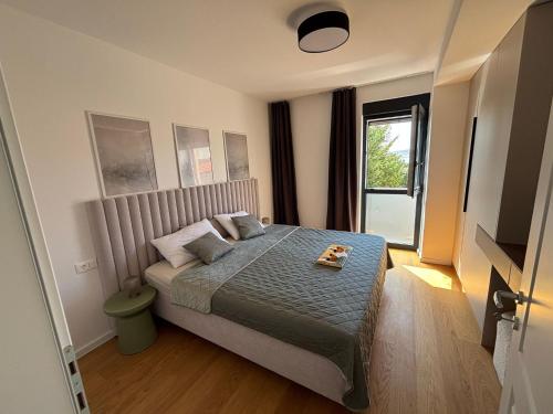 a bedroom with a bed with a tray on it at POLAI Seafront Apartment in Seline