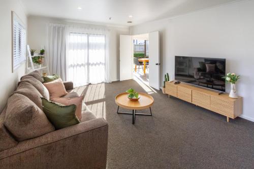 a living room with a couch and a television at Urban Nest on Perth 3BR 1 and a half Bath Free Parking in Christchurch