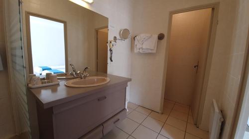 a bathroom with a sink and a mirror and a shower at Bergerie du Château - Lacapelle Marival in Lacapelle-Marival