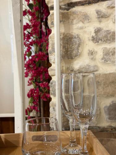 two empty wine glasses sitting on a wooden table at Casa Palma Boutique Hotel in Vlorë