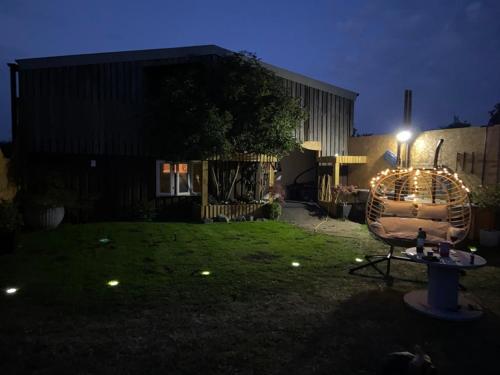 a backyard at night with a chair in the yard at The Cosy Hide - A romantic rural retreat for 2 in Cottenham