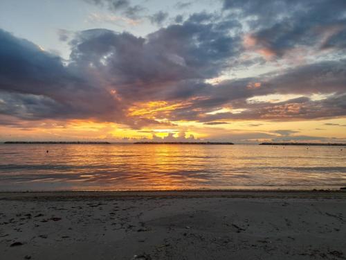 a sunset on a beach with the ocean at Casa al mare Teresa in Porto SantʼElpidio