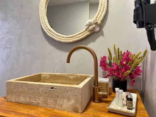 a stone sink on top of a wooden table at Casa Palma Boutique Hotel in Vlorë