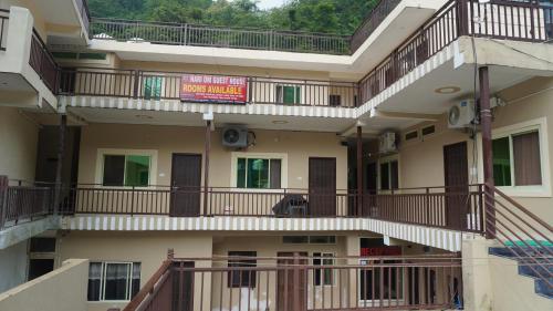 an external view of a building with balconies at Hari Om Guest House in Narendranagar