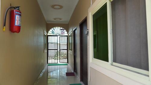a hallway with a fire hydrant and a window at Hari Om Guest House in Narendranagar