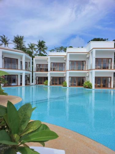 a large swimming pool in front of a building at Resort Deja Vu in Siquijor