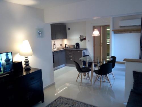 a kitchen and dining room with a table and chairs at Villa du Chateau in Nice