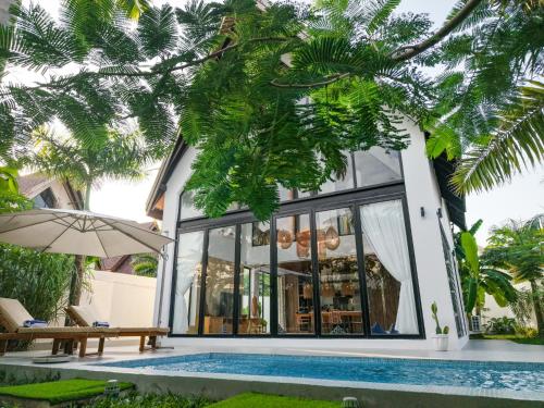 a villa with a swimming pool and a house at Emerald Villas by Paje Emerald Escapes Ltd in Paje