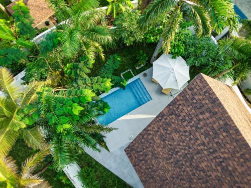 an overhead view of a swimming pool with an umbrella at Emerald Villas by Paje Emerald Escapes Ltd in Paje