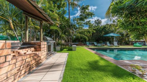 an image of a backyard with a swimming pool and grass at Shanti Ghar Guest House in Tamarin