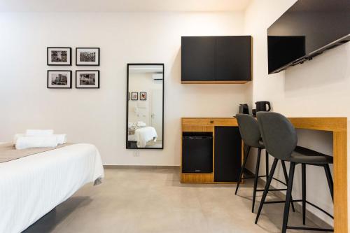 a bedroom with a bed and a desk and a mirror at Capo D'Amuri in Palermo