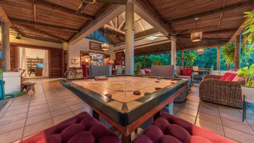 a large living room with a ping pong table at Shanti Ghar Guest House in Tamarin