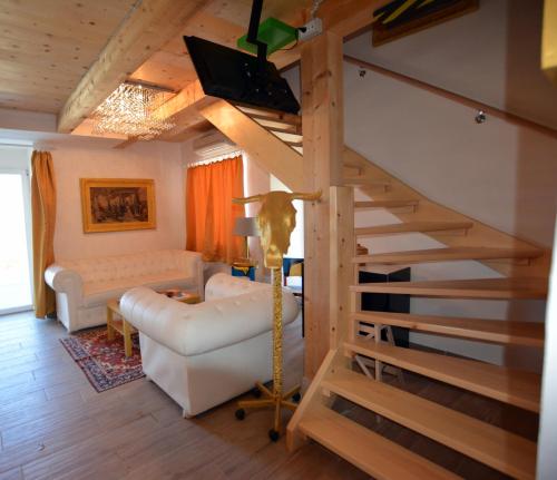 a living room with a spiral staircase with a couch at Art House Vižinada in Vižinada