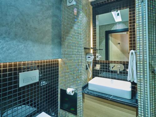 a bathroom with a sink and a mirror at Four-G Hotel in Istanbul