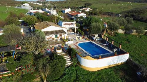 an aerial view of a house with a swimming pool at Monte da Freira in Bencatel
