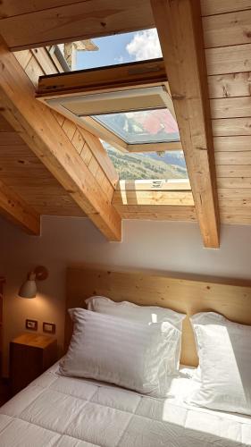 a bedroom with a bed with a large window at Kalemi Twin Boutique Hotel in Gjirokastër