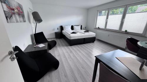 a living room with a couch and a table at 24-7 Living - Lüdinghausen Apartments in Lüdinghausen
