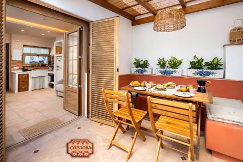 a kitchen and dining room with a table and chairs at Mi Andalusia Hotel Experience in Málaga