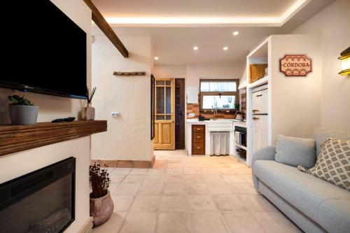a living room with a couch and a flat screen tv at Mi Andalusia Hotel Experience in Málaga