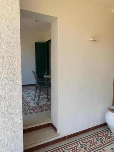a hallway with a table and a chair in a room at Park House in Mondello