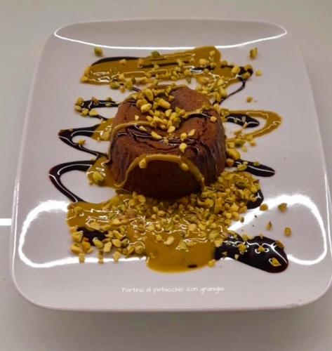 a chocolate dessert on a white plate with yellow sauce at Hotel Astoria in Torri del Benaco