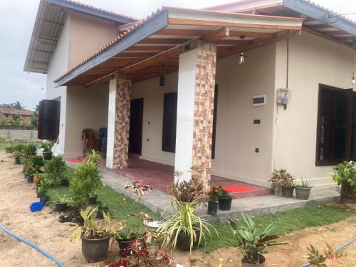 a house with plants in front of it at Oyster bay villas Arugambay in Arugam Bay