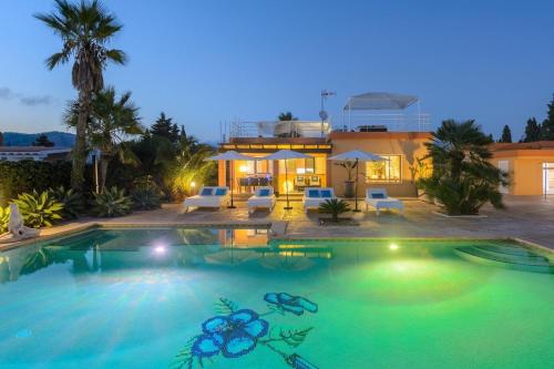 a large swimming pool in front of a house at Tranquil Haven in Ibiza City, 1254 in Sant Francesc de s'Estany