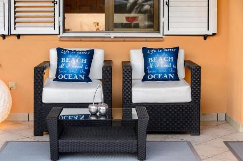 two wicker chairs and a coffee table on a patio at Tranquil Haven in Ibiza City, 1254 in Sant Francesc de s'Estany